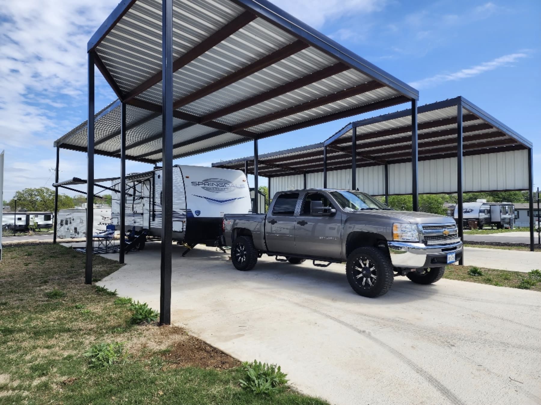 Covered RV site with overhead solar shade at Blessing Community